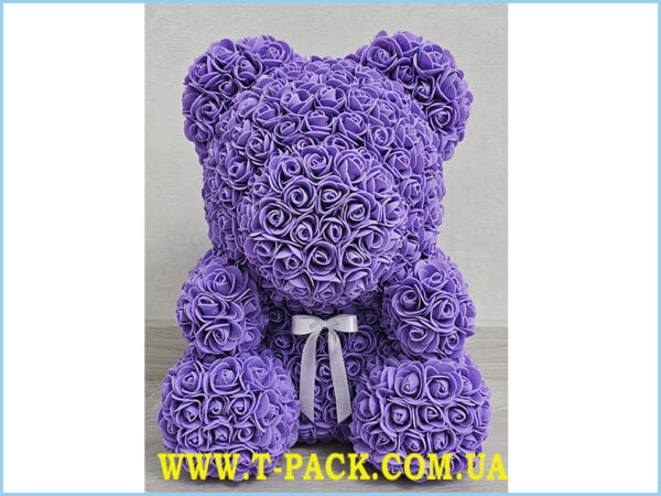 Purple rose teddy bear with a bow.